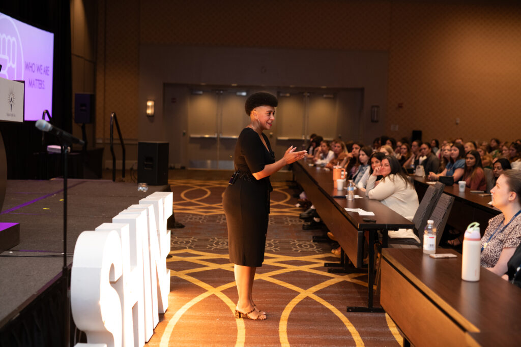 Longshot of Christina on stage at Sigma Delta Tau's national convention in 2024.